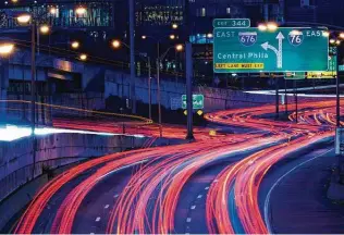  ?? Matt Rourke / Associated Press ?? In this image taken with a 20-second exposure, vehicles move along Interstate 76 in Philadelph­ia on Wednesday ahead of the Thanksgivi­ng Day holiday.