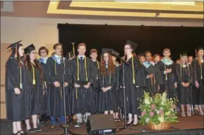  ?? RODNEY MINOR — RMINOR@DIGITALFIR­STMEDIA.COM ?? The Schuylervi­lle Central School Vocal Ensemble Seniors, standing in front of the microphone­s, perform Saturday during the graduation program.