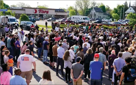  ?? MATT ROURKE — THE ASSOCIATED PRESS ?? People gather near the scene of Saturday’s mass shooting at a supermarke­t in Buffalo, N.Y., on Sunday. Many were filled with grief and anger.