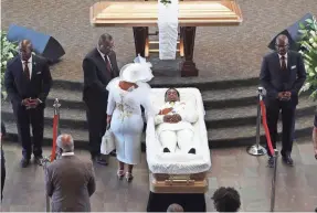  ?? AP ?? Tomika Miller, the wife of Rayshard Brooks, touches her husband during a family visit just before a public viewing at Ebenezer Baptist Church on Monday.