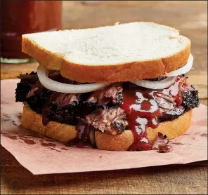  ?? The New York Times/TARA DONNE ?? Barbecued brisket served Texas-style, with onions and sauce on white bread.