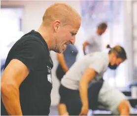  ?? DAN JANISSE ?? Matt Ottogalli guts out one of the 145 repetition­s he performed during the Crews & Brews 20 for 20 burpee event at the Garage Gym in Amherstbur­g on Sunday.