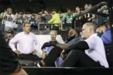  ?? MATT ROURKE — THE ASSOCIATED PRESS ?? Fans cheer in support as Eagles offensive tackle Jason Peters, second from bottom right, is carted off the field during the second half Monday night at Lincoln Financial Field.