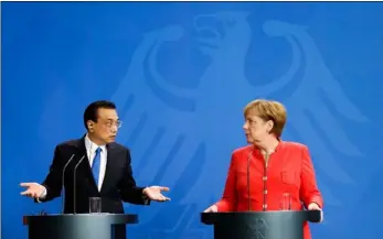  ??  ?? German Chancellor Angela Merkel (right) and Chinese Premier Li Keqiang (left) brief the media during a meeting in the chanceller­y in Berlin, on Monday. AP PhoTo/mIrIAm KArouT