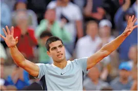  ?? — AP ?? Carlos Alcaraz of Spain celebrates beating countrymat­e Albert Ramos-Vinolas in their French Open second round match at Roland Garros Stadium in Paris on Wednesday. Alcaraz won with a 6-1, 7-6 (9-7), 7-5, 6-2 (2-7), 6-4 scoreline.