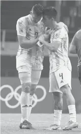  ?? MARTIN MEJIA/AP ?? Argentina’s Adolfo Gaich, left, and Hernan De Lafuente react after a 1-1 draw Wednesday against Spain. Argentina did not advance out of pool play.