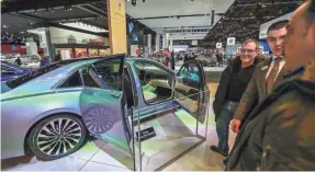  ?? KIMBERLY P. MITCHELL/USA TODAY NETWORK ?? People look at the 2019 Lincoln Continenta­l Coach Edition, at the North American Internatio­nal Auto Show at Cobo Center in Detroit in 2019. The fate of auto shows may be up in the air this year.