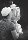  ?? Associated Press photo ?? Brooks Koepka holds the Wanamaker Trophy after winning the PGA Championsh­ip golf tournament at Bellerive Country Club, Sunday in St. Louis.