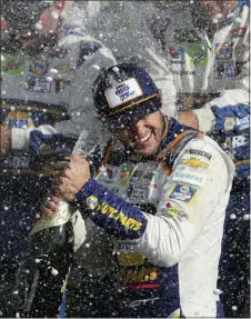  ?? JOHN MUNSON — THE ASSOCIATED PRESS ?? Chase Elliott celebrates his victory with his pit crew after winning a NASCAR Cup Series auto race at Watkins Glen Internatio­nal, Sunday in Watkins Glen, N.Y.