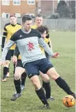  ??  ?? Traf Reserves’ Joe Logan holds onto the ball