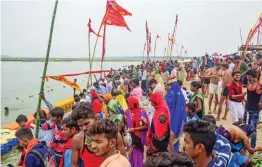  ?? — PTI ?? Devotees gather at Sangam to take a holy dip on the occasion of Bada Mangal festival, amid COVID-19 pandemic, in Prayagraj on Tuesday.