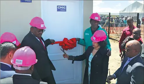  ?? PROVIDED TO CHINA DAILY ?? Lindwe Sisulu, minister of human settlement­s, cuts the ribbon for the sample house built by CMIG Drawin, at Ekurhuleni in Gauteng province, South Africa.