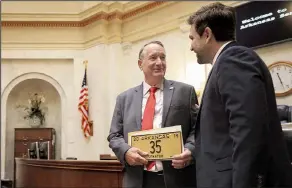  ?? Arkansas Democrat-Gazette/STATON BREIDENTHA­L ?? Newly sworn-in state Sen. Frank Glidewell, R-Fort Smith, gets his official license plate from Senate President Pro Tempore Jonathan Dismang, R-Searcy, Monday on the floor of that body’s chamber in the state Capitol. Senators also discussed video-streaming committee meetings. Related article, 3B