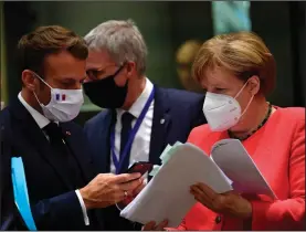  ?? (AP/John Thys) ?? French President Emmanuel Macron (second left) talks with German Chancellor Angela Merkel on Monday during a meeting at the EU summit in Brussels.