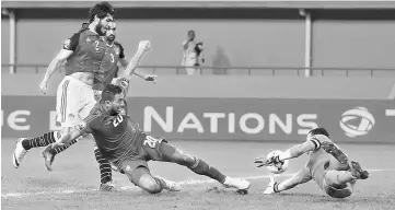  ?? Reuters photo ?? Egypt’s goalkeeper Essam El Hadary (right) saves the ball from Morocco’s Aziz Bouhaddouz in the game during the African Cup of Nations quarter finals at Stade de Port Gentil in Gabon in this Jan 29 file photo. —