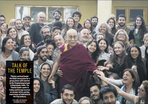  ??  ?? Tibetan spiritual leader the Dalai Lama poses for a group photo with tourists at the Tsuglakhan­g temple in Dharmsala, India. The Tibetan leader spoke to Indian and foreign tourists on secular ethics and the importance of tolerance in the 21st century.