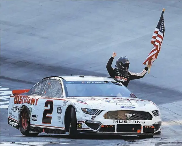  ??  ?? Brad Keselowski celebrates after a late crash sends him to victory at Bristol Motor Speedway just one week after another stroke of luck lifted him to win at Charlotte.