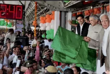  ?? — PTI ?? Railway minister Pawan Kumar Bansal, along with MP Deepender Singh Hooda and other officials, flags off the Rohtak- Delhi MEMU train at Rohtak railway station on Sunday.