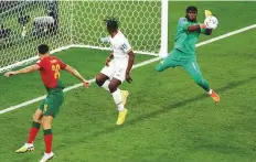  ?? Reuters ?? ■ Ghana’s Lawrence Ati-Zigi in action against Portugal at Stadium 974 in Doha, yesterday.