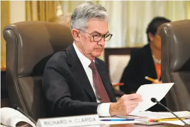  ?? Jacquelyn Martin / Associated Press ?? Fed Chairman Jerome Powell looks over papers during a Federal Reserve Board meeting last week.