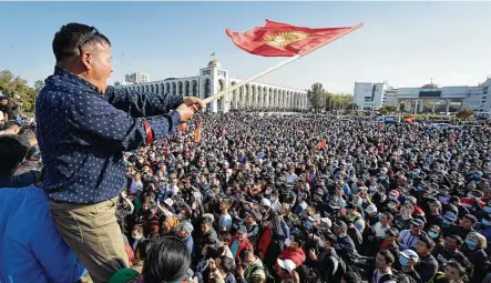  ?? Vladimir Voronin / Associated Press ?? People protest during a rally Monday against the results of a parliament­ary vote in Bishkek, Kyrgyzstan. Early results of a parliament­ary election give the majority of seats to two parties with ties to the ruling elites amid allegation­s of vote buying.