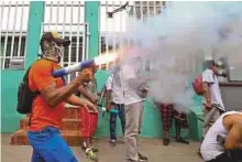  ?? AP ?? A masked protester fires a homemade mortar in the Monimbo neighbourh­ood during clashes with police, in Masaya, Nicaragua.