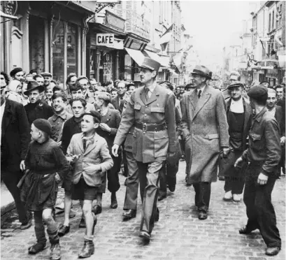  ??  ?? Lead by excited children, General Charles de Gaulle walks through the streets of Paris after France’s liberation from Nazi Germany in 1944