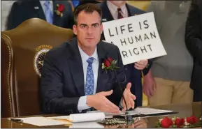  ?? (AP/Sue Ogrocki) ?? Oklahoma Gov. Kevin Stitt speaks April 12 after signing into law a bill making it a felony to perform an abortion, punishable by up to 10 years in prison, in Oklahoma City.