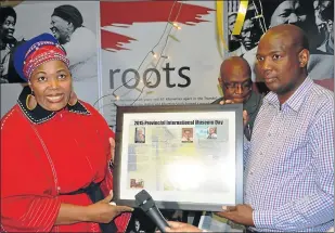  ?? Picture: TEMBILE SGQOLANA ?? FOR YOU: The Sisulu family received a poster recognisin­g work done by Walter and Albertina Sisulu from the Eastern Cape department of sport, recreation, arts and culture MEC on Tuesday during the official opening of the Walter and Albertina Sisulu Travelling Exhibition at the Frontier Museum in Queenstown, from left, MEC Pemmy Majodina and Vuyolwethu Sisulu