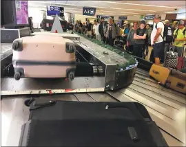  ?? MIKE FRANKEL— STAFF ?? Luggage arrives for a crowd of travelers at Mineta San Jose Internatio­nal Airport on Wednesday. When things go awry, traveler Chris Collins advises, “Just laugh.”