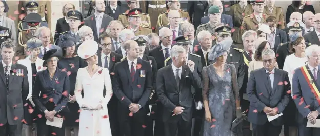  ??  ?? 0 Poppy petals fall on the dignitarie­s – including the Duke and Duchess of Cambridge and the king and queen of Belgium – at the Menin Gate. Below, the duke’s wreath