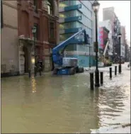  ?? PATRICIA MADEJ/THE PHILADELPH­IA INQUIRER VIA AP) ?? Water covers a street after a water main broke in Philadelph­ia on Tuesday morning.