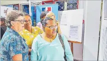  ?? Picture: FIJI SPORTS COUNCIL ?? Lyndall Fisher and Della Shaw Elder admire pictures at the exhibition at the Alliance Francaise in Suva.