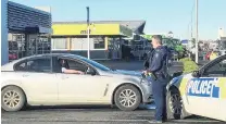  ?? PHOTO: SHARON REECE ?? Man down . . . Police man the cordon at the scene of a shooting in Invercargi­ll on Saturday morning.