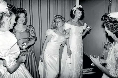  ?? WAIKATO MUSEUM ?? Jo-Anne Griffin, centre-right, and her attendant Victoria Dauphin have a lastminute cigarette at the Bride of the Year competitio­n.