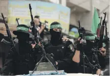  ?? AFP ?? Members of Hamas’s Al Qassam Brigades during the funerals of six comrades killed in an unexplaine­d explosion