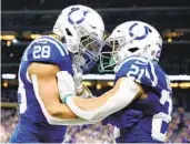  ?? ANDY LYONS GETTY IMAGES ?? Jonathan Taylor (28) and Nyheim Hines of the Colts celebrate after Hines’ early touchdown vs. the Pats.