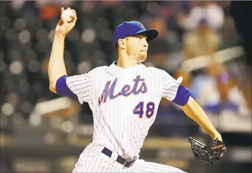  ?? Kathy Willens / Associated Press ?? New York Mets starting pitcher Jacob deGrom throws during the first inning of a game against the Miami Marlins in New York on Sept. 25. DeGrom says he’ll be ready for Opening Day, but the team isn’t sure.