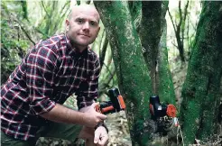  ?? AP PHOTOS ?? Goodnature co-founder Robbie van Dam, poses with his company’s resetting rat traps at Polhill Reserve in Wellington, New Zealand.