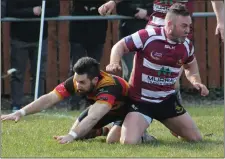  ??  ?? Stewart O’Brien is tackled to deny him a try.