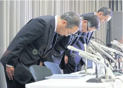  ?? JIJI PRESS/AFP ?? Toshihiro Suzuki, president of Suzuki Motor Corp, centre, bows with other executives during a press conference in Tokyo yesterday.