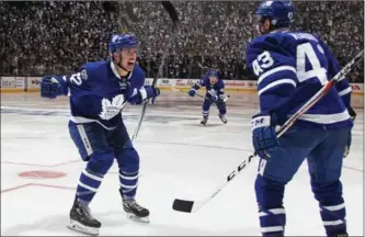  ?? CLAUS ANDERSEN, GETTY IMAGES ?? Tyler Bozak, left, of the Toronto Maple Leafs celebrates his game-winning goal in the first overtime period against the Washington Capitals in Game 3 with Nazem Kadri.