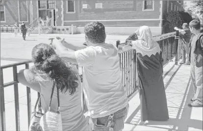  ??  ?? Parents wait for their children to leave Peter Reinberg Public school on the Northwest Side.
| AL PODGORSKI~SUN-TIMES