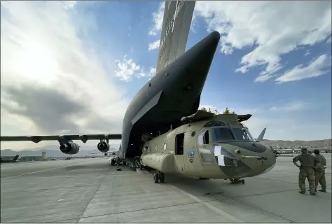 ?? DEPARTMENT OF DEFENSE VIA AP ?? A CH-47 Chinook from the 82nd Combat Aviation Brigade, 82nd Airborne Division is loaded onto a U.S. Air Force C-17 Globemaste­r III at Hamid Karzai Internatio­nal Airport Aug. 28in Kabul, Afghanista­n.