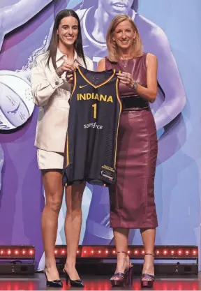  ?? BRAD PENNER/USA TODAY SPORTS ?? Caitlin Clark poses with WNBA commission­er Cathy Engelbert after being selected by the Fever with the No. 1 pick in the WNBA draft.