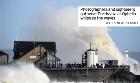  ?? WALES NEWS SERVICE ?? Photograph­ers and sightseers gather at Porthcawl at Ophelia whips up the waves