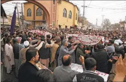  ?? MUHAMMAD SAJJAD AP ?? People carry the coffins of victims of Friday’s suicide bombing in Peshawar, Pakistan, on Saturday. The death toll rose to 63.