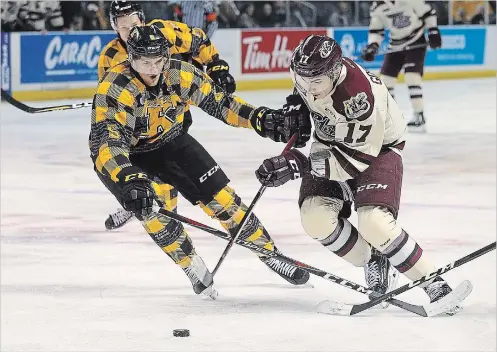  ?? IAN MACALPINE KINGSTON WHIG-STANDARD ?? Peterborou­gh Petes Pavel Gogolev tries to drive past Kingston Frontenacs defence man Jacob Paquette during Ontario Hockey League action at the Leon's Centre in Kingston on Friday.