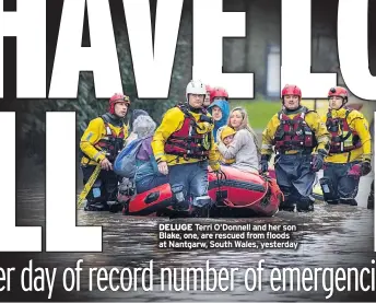  ??  ?? DELUGE Terri O’Donnell and her son Blake, one, are rescued from floods at Nantgarw, South Wales, yesterday