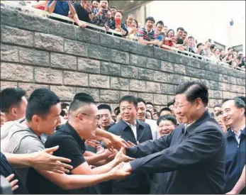  ?? LI XUEREN / XINHUA ?? President Xi Jinping is greeted by students and faculty at the China University of Political Science and Law in Beijing on Wednesday.